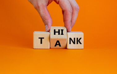 Think tank symbol. Businessman turns a wooden cube and changes the word tank to think. Beautiful...