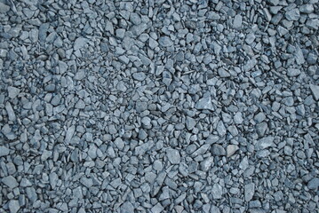 Gravel path in the park. Fine pebbles. An alley in the garden. An interesting pattern for wallpaper, background.