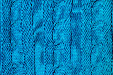 blue fabric, knitted from threads with a braided pigtail pattern