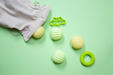 Set of physiotherapy accessories strewing on green background