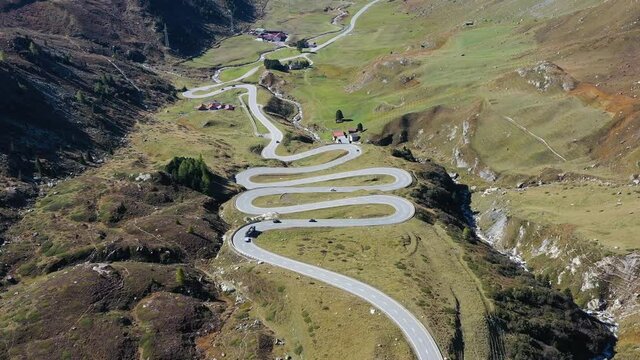 Julier Pass, Surses, Switzerland. Natural scenery in the highlands. A road with many curves among the mountains. Aerial landscape from drone. 