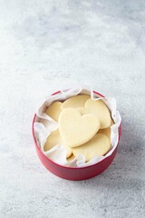 Shortbread cookies in shape of heart in red box on grey background. Mother's day, Women's day, Valentine's Day. Homemade present.