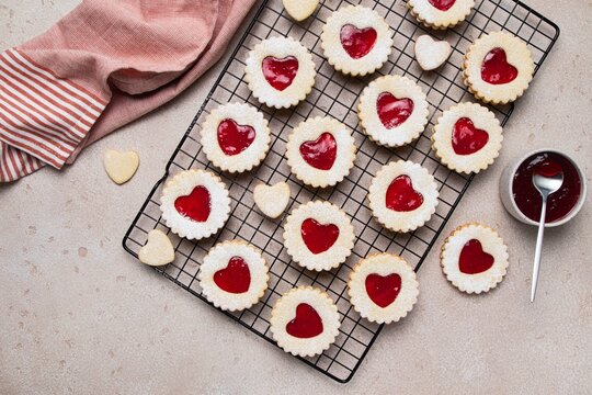 Linzer cookies in shape of heart with jam on light background. Mother's day, Women's day, Valentine's day. Homemade present.