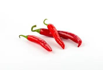 Fotobehang Three red chili peppers isolated on white background. © sergeyyrev