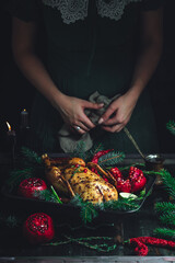 Christmas duck with pomegranates and lime surrounded by spruce branch