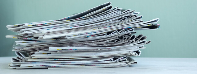 A stack of newspapers. Business news, finance. Latest information. Copy space