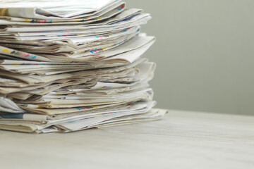 A stack of newspapers. Business news, finance. Latest information. Copy space