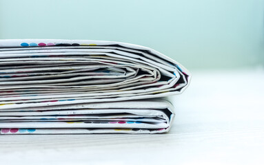 A stack of newspapers. Business news, finance. Latest information. Copy space