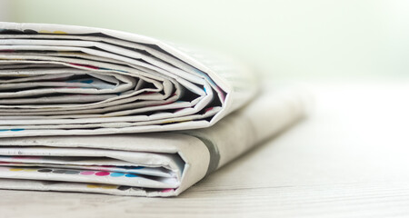 A stack of newspapers. Business news, finance. Latest information. Copy space