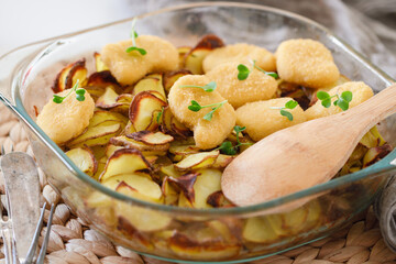 Homemade baked potatoes with nuggets on a white Scandinavian table. Lunch