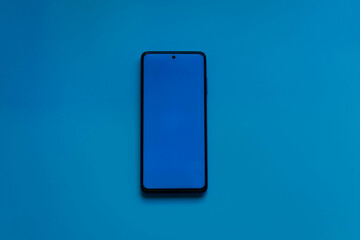 Mobile phone on blue desktop with copyspace. Banner