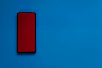 Mobile phone on blue desktop with copyspace. Banner