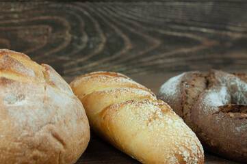 fresh country bread on a wooden background in