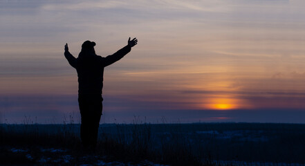 Prayer. Repentance. A man with his hands raised against the sky. Pray to God. Worship