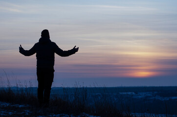 Fototapeta premium Prayer. Repentance. A man with his hands raised against the sky. Pray to God. Worship