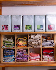 stacks of colorful fabrics in the workshop