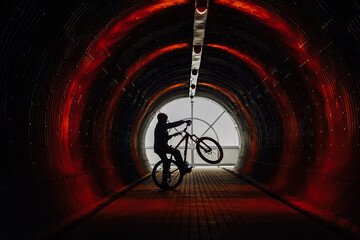 silhouette of a cyclist in the tunnel. type of active recreation, sports lifestyle
