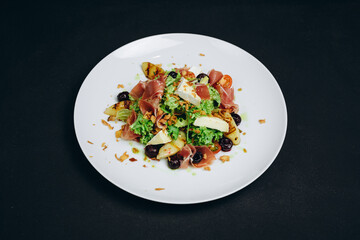 The new dish or salad is made by the professional.