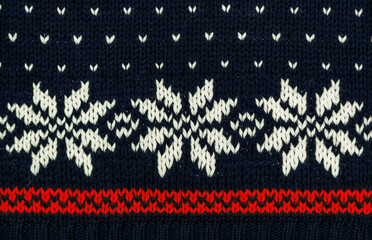 Traditional knitted blue sweater with snowflakes
