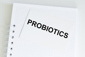 Blue card with text PROBIOTICS on a notepad that sits on a table