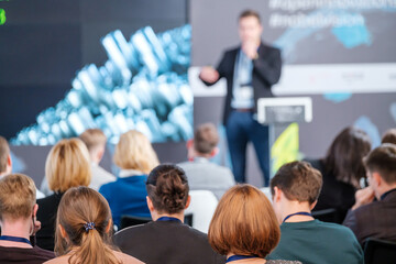 Audience watching presentation during business seminar