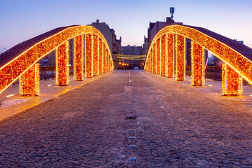 Fototapeta premium Poznan. The Bishop Jordan Bridge in the early morning festive illumination.