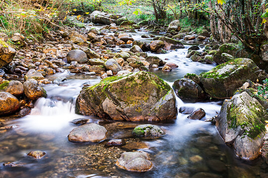Photograph of a river with silky water effect.The photo has been shot on the Alba route that starts from the famous Asturian town Soto de Agues.