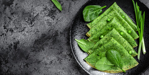 green colored pancake with spinach in dough with vegetables, Healthy breakfast. Delicious breakfast or snack, Clean eating, dieting, vegan food concept. top view