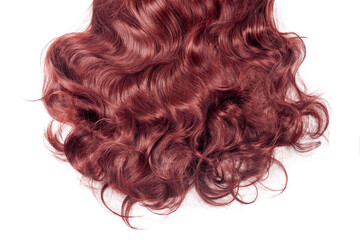 Red hair isolated on white. Wavy long curly hair close up, hair extensions, materials and cosmetics, hair care, wig. Hairstyle, haircut or dying in salon, long red wig.