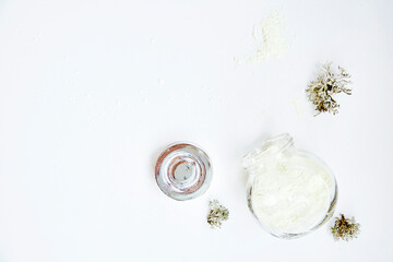 Natural wellness face care cosmetic on white background. Alginate mask. Organic forest moss. Hyaluronic and moisturizing cosmetic. Dermatology natural products . Top view, copy space