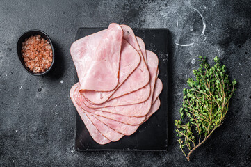 Squared slices of lean pork ham. Black background. Top view