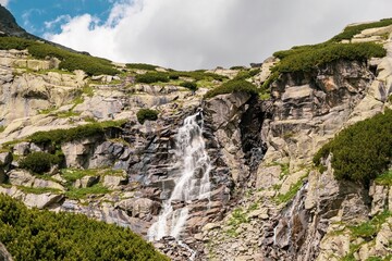 Fototapeta na wymiar Amazing view of the waterfall in Tatra mountains in Slovakia. 
