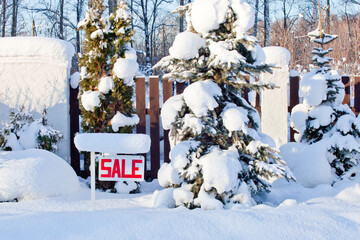 sale sign in winter with snow