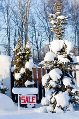 sale sign in winter with snow