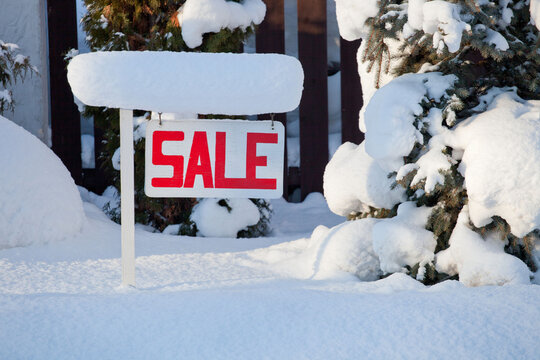 sale sign in winter with snow