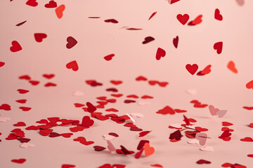 a lot of flying and falling hearts on rose background. Valentine's Day. symbol of love