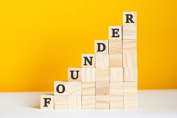 the word founder is written on a wooden cubes, concept - obrazy, fototapety, plakaty