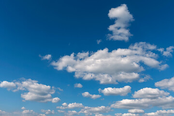 bright blue sky with group of white cumulus clouds as a natural background