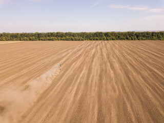 Fototapeta na wymiar Aerial view of Harvesting in the Golden Wheat Field