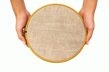 Embroidery hoop with natural linen fabric.