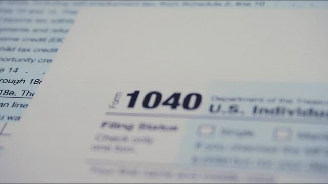 Blank Form 1040 U.S. individual income tax return. Tax payment time concept. Filing taxes document