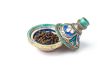Black pepper corns in a mini Moroccan tagine
