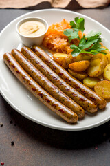 franconian sausages with fried cabbage and potatoes and mustard macro close up
