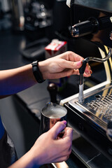 Professional barista preparing coffee. Barista making espresso coffee with automatic coffee machine