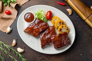 Barbecue pork ribs on dark brown concrete table top view