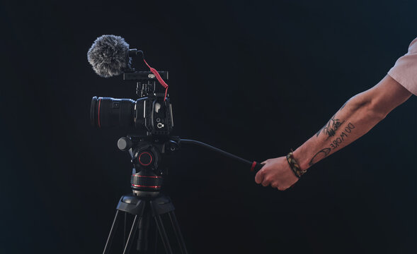 Filmmaker or cinematographer shooting with a professional camera cinematic videos. Documentaries, movies and TV series cameraman.