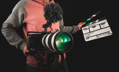 Filmmaker or cinematographer shooting with a professional camera cinematic videos. Documentaries, movies and TV series cameraman.