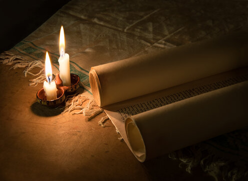 Ancient scroll lit by candlelight
