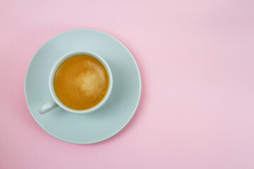 a cup of coffee on pink background