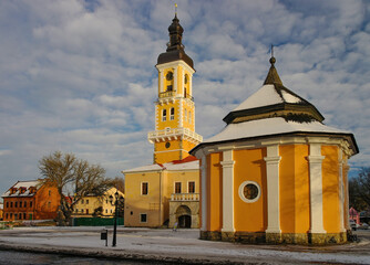 Fototapeta na wymiar Armenian Well and Town Hall in Kamianets-Podilskyi, Ukraine at sunny winter day